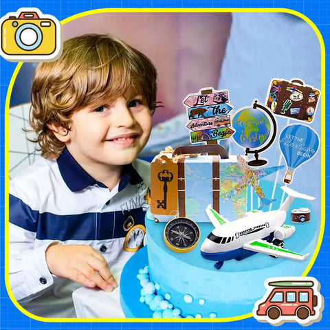 Adventure Travel Cake Topper Set For Party Decor with airplane, map, suitcase, and compass on a blue cake with a child nearby