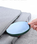 Tempered Glass Top Cup Warmer Pad With Digital Display And Auto Timer To Keep Your Morning Brew Piping Hot And Dodge The Cold Coffee Blues On Busy Weekdays in hand beside a gray bag.