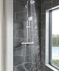 Tempesta Cosmopolitan 2.5 GPM 4-Spray Hand Shower In Starlight Chrome with water flowing, installed in modern bathroom
