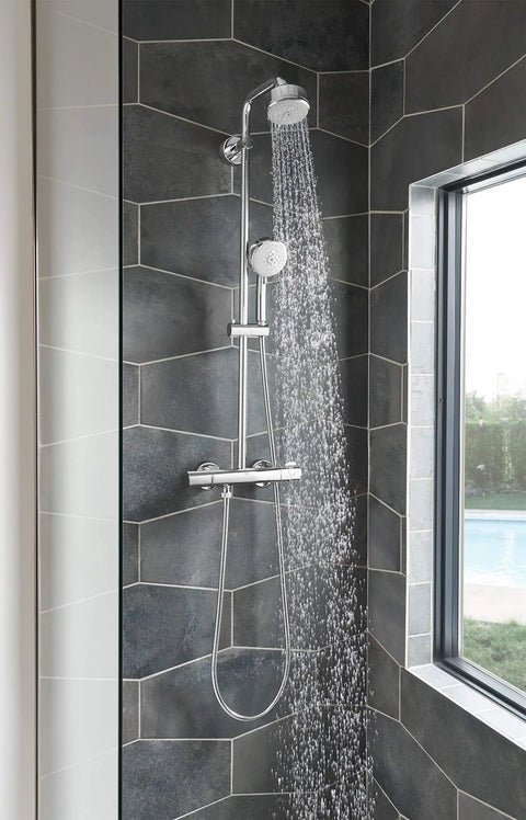 Tempesta Cosmopolitan 2.5 GPM 4-Spray Hand Shower In Starlight Chrome with water flowing, installed in modern bathroom