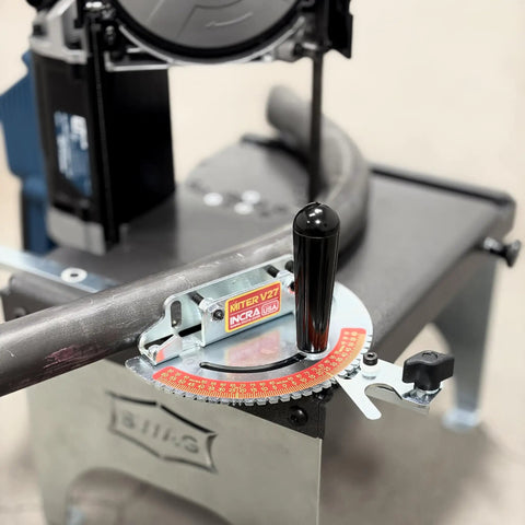 V27 Miter Gauge for Woodworking Precision With AngleLOCK Quick Tool Free Adjustment Four Expansion Joints Eliminate Side Play USA Made Built Tough for Accurate Angles and Safe Cuts mounted on table saw with guide rail in background.