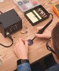Person using Ultrasonic Levitation Soldering Kit For Beginners A Hands On STEM Electronics DIY Practice Set with tools on table