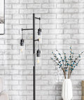 Black Floor Lamp With Three Glass Shade Branches Dope Industrial Tree Lamp For Living Room Or Office 64 Inch Tall Modern Farmhouse Style Includes Three 8W LED Edison Bulbs against a brick wall.