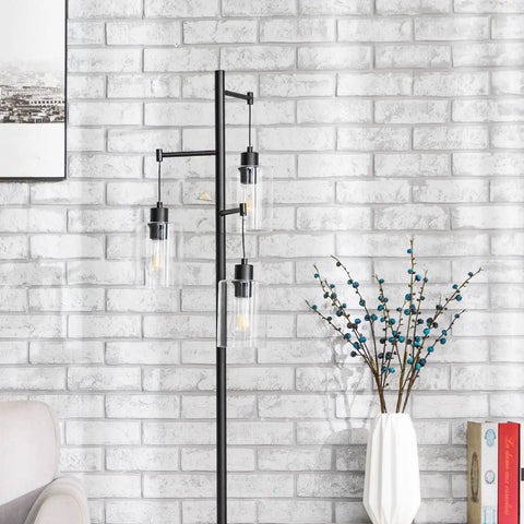 Black Floor Lamp With Three Glass Shade Branches Dope Industrial Tree Lamp For Living Room Or Office 64 Inch Tall Modern Farmhouse Style Includes Three 8W LED Edison Bulbs against a brick wall.
