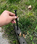 Hand installing stake of Extra Tall 4 Inch Lawn Edging Kit, 33 Ft Flexible Garden Border With 50 Stakes, Durable Plastic Fence Edge