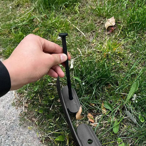 Hand installing stake of Extra Tall 4 Inch Lawn Edging Kit, 33 Ft Flexible Garden Border With 50 Stakes, Durable Plastic Fence Edge