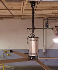 Heavy Duty Twenty Foot Industrial Ceiling Fan Using High Volume Low Speed Technology mounted in a warehouse setting.