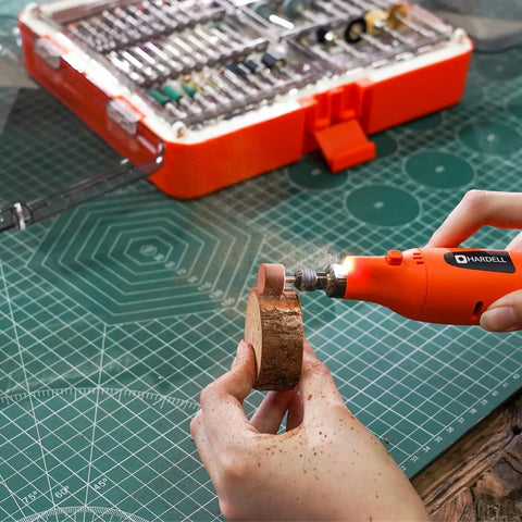 Heavy Duty 508 Piece Rotary Tool Accessory Kit in use, grinding wood with Dremel tool on cutting mat.