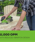 Person using Cordless 24V Mouse Detail Sander With 11,000 OPM Orbit on a wooden surface outdoors.
