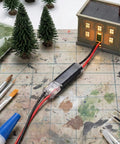 60 Pcs Quick Clip Wire Connectors Set For 18 To 22 AWG Low Voltage LED Strips shown connecting model house on workbench