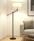 Mid Century Modern Dope Height Adjustable LED Floor Lamp in living room with beige lampshade, rustic design next to sofa.