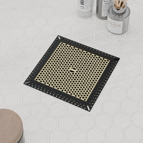 Solid Square Shower Drain Hair Catcher Non Moving Drain Cover Stopper Filter with black and gold design on hexagon tile flooring.