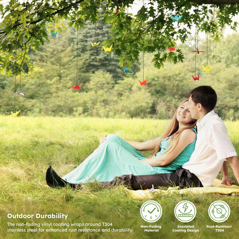 Couple sitting under trees with hanging decorations, showcasing the outdoor use of Black Vinyl Coated Wire Rope One Sixteenth Inch 328 Feet Stainless Steel Cable With 150 Aluminum Crimp Sleeves For String Lights Clotheslines Trellis And Picture Hanging Easy Install.