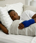 Person sleeping with Night Wrist Support For Carpal Tunnel Relief, Left Or Right, Adjustable, Breathable Sleeve in blue.