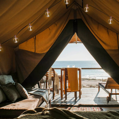 Indoor 2 Pack G50 LED String Lights With Vintage Filament Bulbs, 24 Feet Each, in a cozy tent setting by the beach