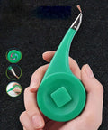 Hand holding a High Speed Heat Conducting Soldering Wick with a green handle for PCB repair, safe anti-scald feature.