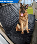 Heavy Duty Waterproof Bench Car Seat Cover Protector For Dogs Nonslip Universal Fit For Cars Trucks And SUVs Keeps Upholstery Safe From Fur Scratches And Urine Perfect For Pets And Passengers Black with dog seated on quilted fabric in car.