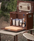 Sundowner Portable Travel Bar Kit with handcrafted wooden case, tools, tumblers, and shaker for camping or travel, open view.