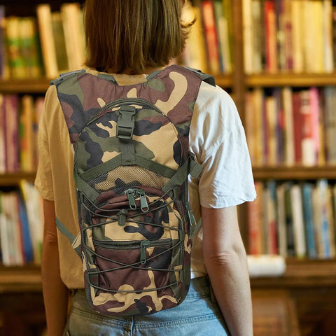 Go To Lightweight Hiking Backpack For Women, Oxford Cloth Daypack In Jungle Camo worn by woman indoors