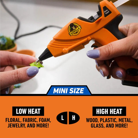 Dual Temp Mini Hot Glue Gun with Precision Nozzle in use for delicate crafting, featuring easy squeeze trigger and built-in safety stand.