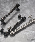 Three metal cabinet pulls on a textured surface; includes black and silver variants with durable design