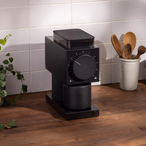 64mm Flat Burr Electric Coffee Grinder Built For Brewed Coffee Lovers With 31 Grind Settings, shown in a kitchen setting on a counter.