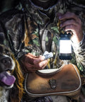 Hunter with dog using Siege X Rechargeable Lantern Flashlight 360 Degree Light 300 Lumen Output in a forest setting at night.