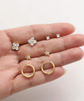 Gold Stud Earrings Set For Women With Nine Pairs Of CZ Flower, Ball, And Star Huggie Hoops For Multiple Piercings, Flat Back Cartilage Tragus Earrings, Stacks, Gold Silver Plated, Everyday Shine. Close-up of gold CZ flower, star, and hoop studs.
