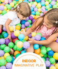 Children playing in a colorful indoor ball pit with various colored plastic balls.