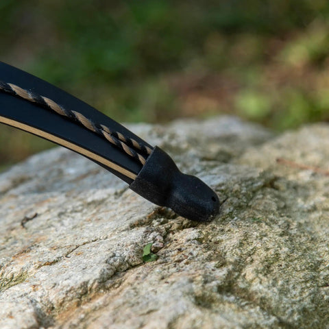 Close-up of a Recurve Bow Tip Protector And Longbow Tip Guard Silicone Tip Shield 2 Pack Archery Hunting Gear on bow tip.