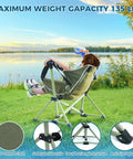 Child relaxing in Kids Hammock Chair with Stand by a lake, showcasing adjustable folding camping chair for travel, supports 135 lbs.