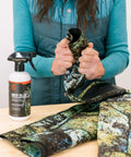 Woman applying Neo Slix Wetsuit Entry Lubricant 16.9 Fl Oz Water Based Silicone Free Formula to wetsuit for easy entry