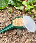 Handheld Seed Planter and Spreader for Lawn and Garden, adjustable five setting seeder tool with seeds in soil.