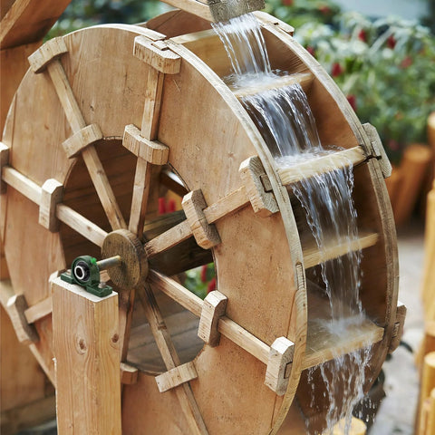 Pillow block bearing UCP204-12 with 3/4 in bore and green housing mounted on a wooden water wheel