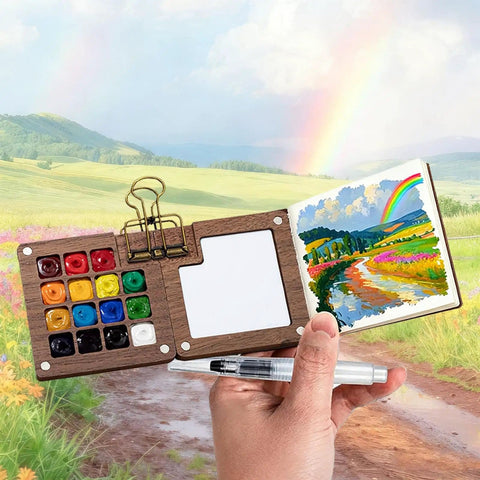 Mini Watercolor Travel Kit With Wooden Palette And Copper Clip Includes 24 Watercolors 6 Brushes And 2 Sketchbooks For Beginners And Painting Enthusiasts On The Go displayed open with painting scenery background