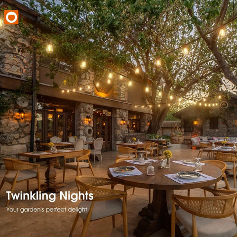 50Ft Outdoor String Lights With 27 Edison Dimmable LED Bulbs Weatherproof And Shatterproof illuminating a patio with trees and tables