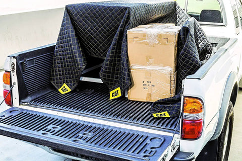 Heavy Duty Moving Blanket With Padded Cushioned Comfort For Every Move Non Woven Fabric 80 By 72 Inches covering boxes in a truck bed