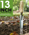 Five In One Garden Weeder Tool With Stainless Steel Head And Wooden Handle shown with 13-inch length in outdoor soil.