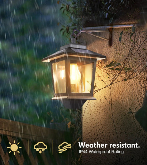 Two Pack Solar Wall Lanterns Outdoor Hanging Lights With Four Solar Panels Dusk To Dawn Led Sconces Anti Rust Waterproof With Hooks 3000K Warm White For Patio Porch Deck shown in rain demonstrating water resistance.