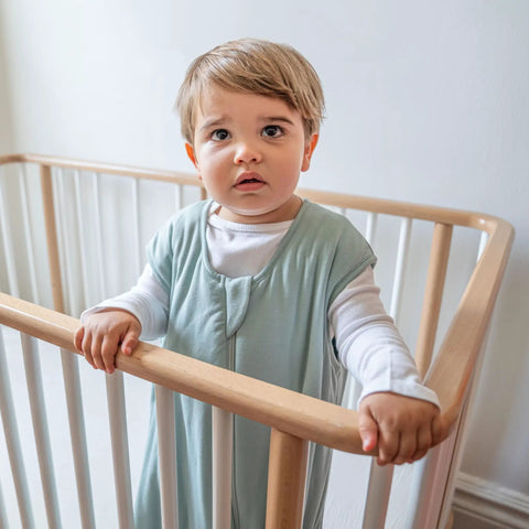 Baby in crib wearing Supersoft Wearable Baby Sleep Sack Made From Bamboo Viscose 1.5 TOG 6 To 12 Months Medium Calm Sage