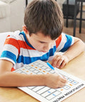 Child using Dry Erase Multiplication Board 9x12 Inch Double Sided Times Table Whiteboard With Easy Wipe Coating For Kids And Students