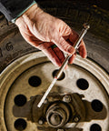Hand holding High Pressure Car Tire Gauge With Pencil Style Tread Depth Meter Built In Deflator Valve One Sixteenth Inch Increments