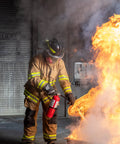 Firefighter using Heavy Duty Five Pound Abc Dry Chemical Fire Extinguisher Rated Two A Ten B C to put out flames.