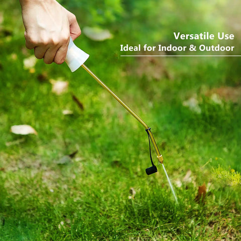 Hand using Diatomaceous Earth Bulb Duster With Long Copper Tube Garden Sprayer Applicator for pest control in a yard