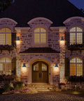 Two Pack Outdoor Wall Sconces With Hammered Metal Shade And Gold Interior illuminating elegant house facade at night