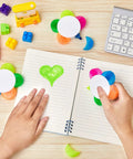 Person using Petals Highlighters Set 140 Pieces In Five Assorted Fluorescent Colors Flower Shape Watercolor Highlighter Pens Five In One Pens on notebook