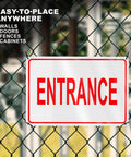 Clear Reflective Entrance Sign For Businesses, 8x12 Inch Rust Free Aluminum, Enter Here, Pre Drilled For Easy Mount, Weatherproof UV Protected Outdoor Sign That Grabs Attention And Directs Guests To The Correct Entry Point. Mounted on chain-link fence with "ENTRANCE" text.