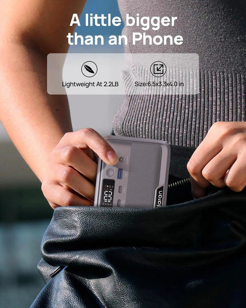 Person holding Pocket Sized Power Station With LiFePO4 Battery, 89.6Wh, 100W Continuous Output And 200W Peak next to a pocket