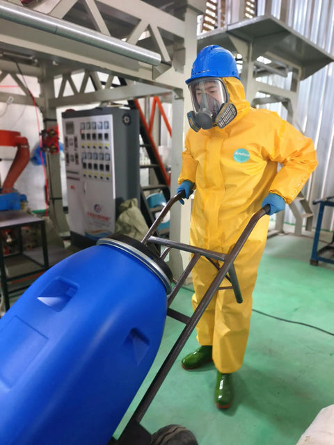 Rugged Chemical Resistant Coveralls With Integrated Boots And Hood For Straight Up Reliable Full Body Safety Engineered Durable Sealed Polyethylene Coated Suit Size S worn by worker handling equipment.