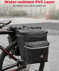34L Waterproof Bike Pannier Bag With Rain Cover for Rear Rack on bike, showing water-resistant PVC layer in rain, black.